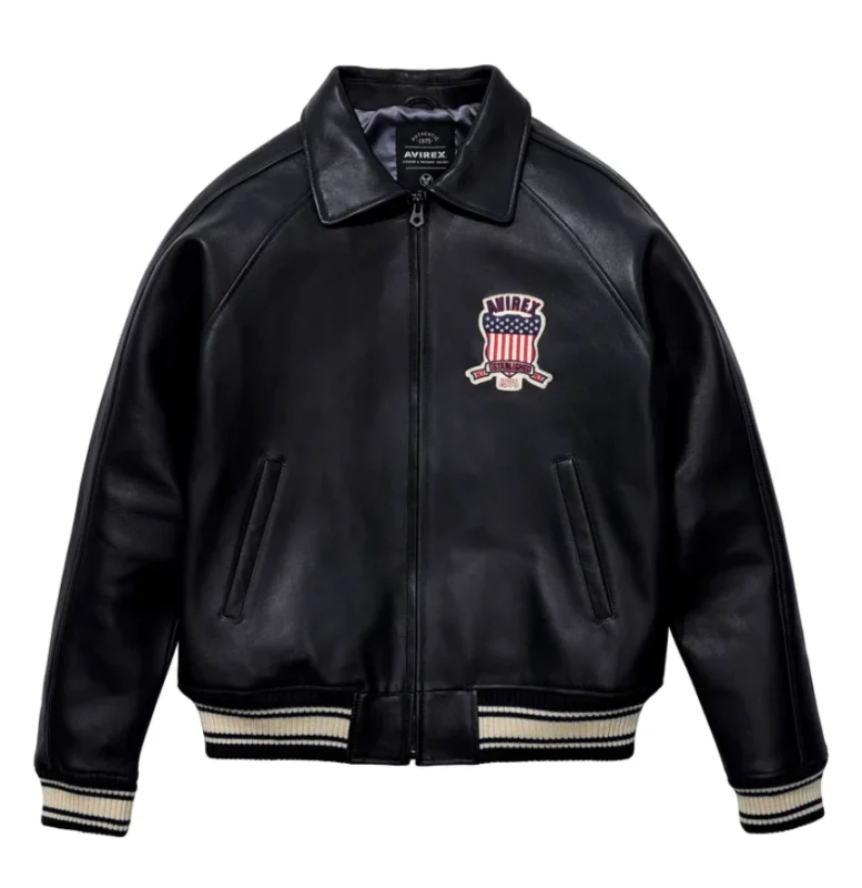 men’s black leather bomber jacket with large AVIREX USA lettering, embroidered patch, striped rib hem and cuffs, and aviator varsity style design.