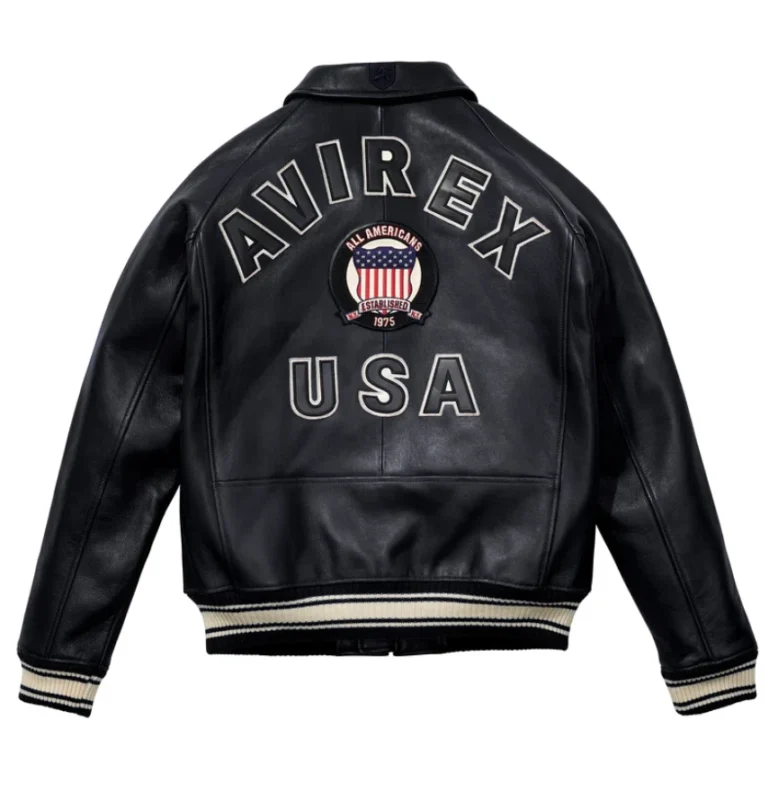 Men’s black leather bomber jacket with front zip closure, shirt collar, ribbed cuffs, side pockets, and aviator varsity patch details.