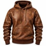 Brown distressed leather hoodie with a textured vintage finish, drawstring hood, brass-tone cord tips, kangaroo pocket, and ribbed cuffs