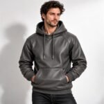 Charcoal grey leather hoodie featuring a lined hood, metal-tipped drawstrings, fine leather texture, and stitched kangaroo pocket.