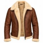 Rich brown leather jacket featuring a cream shearling collar, textured lining, long sleeves, metal zipper, waist buckles and plush trim on a clean white background.