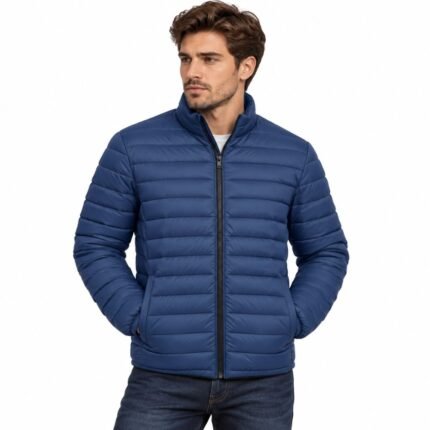 Man wearing the Arctic Dominion men’s blue puffer jacket with horizontal quilted panels, stand collar, full front zipper, and practical side pockets against a white background.