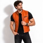 Man wearing the Cinderstrike Orange Leather Vest with a stand collar, silver zipper, and practical chest pockets.
