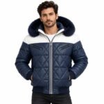 Man wearing the Frostline Blue Quilted Fur Hood Jacket with white shoulder panels, diamond quilting, navy fur-trimmed hood, front zipper, and ribbed cuffs against a white background.
