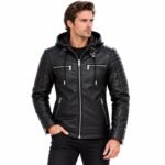 Man wearing a black quilted leather hoodie jacket with padded shoulders, silver zippers, chest pockets, and zippered cuffs against a white background
