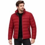 Man wearing the VOLT Red Puffer Jacket with raised collar, horizontal quilted panels, full front zipper, and practical zippered pockets against a white background.