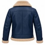 Navy blue shearling leather jacket displaying a structured back with central seam, horizontal shoulder yoke, detailed sleeve stitching, adjustable waist tabs, and cream shearling hem.