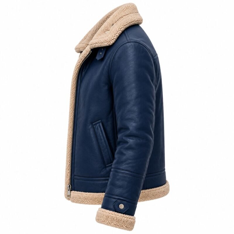 Navy blue shearling leather jacket showing its structured side profile, cream shearling collar and hem, angled pocket, stitched sleeve panels, zipper, and adjustable cuff strap.
